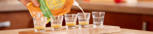 Pouring shots glasses of broth