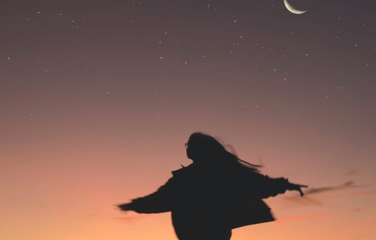 silhouette of woman running at night