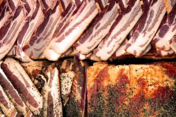 Slabs of bacon with pepper on them