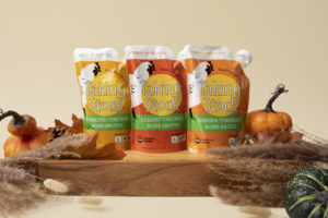 3 pouches of Taking Stock Foods organic chicken bone broth with fall decor