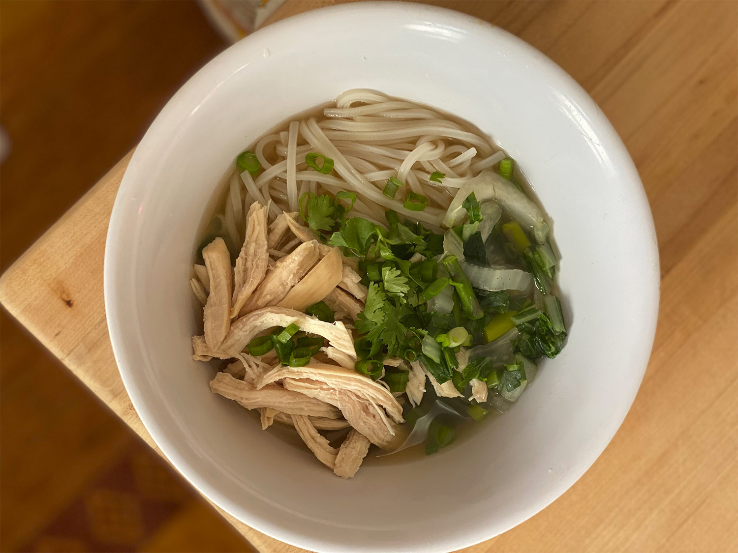 Broth bowls with rice noodles and spring vegetables